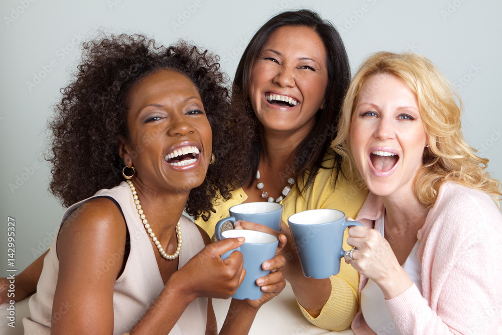 Diverse group of women talking and drinking coffee. Stock Photo Adobe