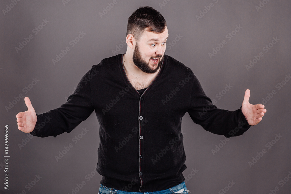 Naklejka premium man holding two hands in front of him and shows the size on white isolated background in studio.