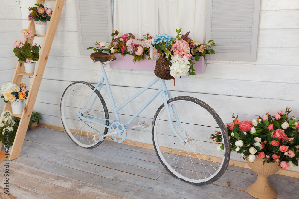 Blue bicycle with a basket of flowers