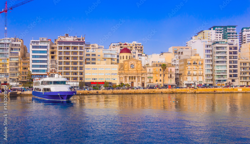 Beautiful panoramic view over the famous harbor of Valletta illuminated by sunset light, in Malta