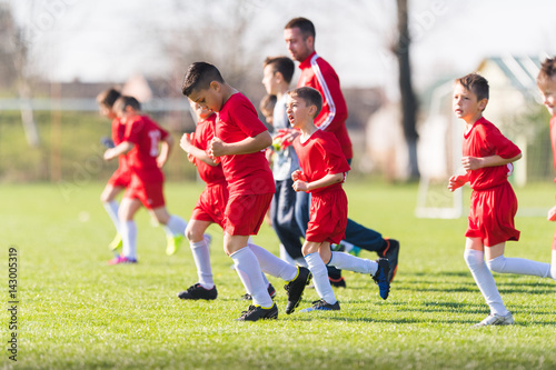 Kids soccer football - children players exercising before match on soccer field © Dusan Kostic