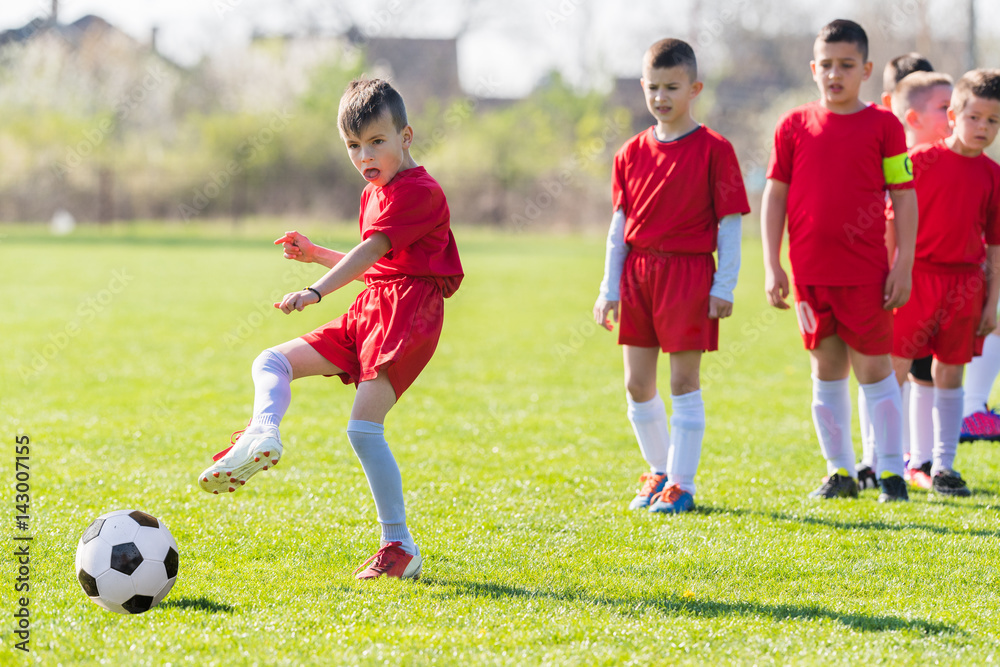 Kids soccer football - children players exercising before match on soccer field