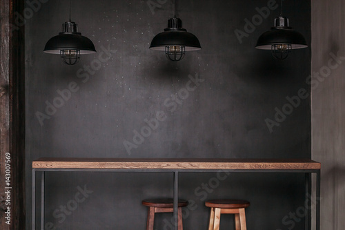 Dinning table set in loft style dining room with black lamps