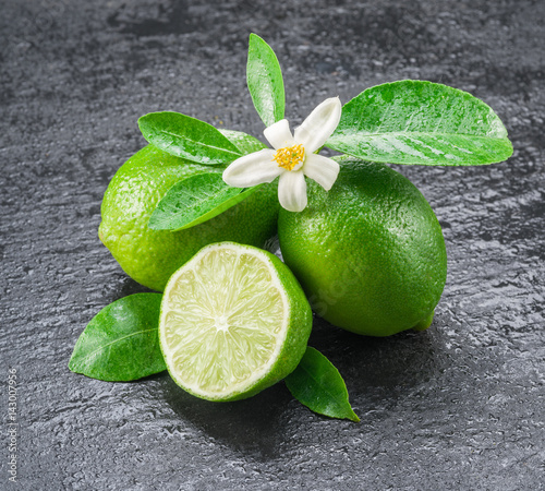 Ripe lime fruits on the gray background.