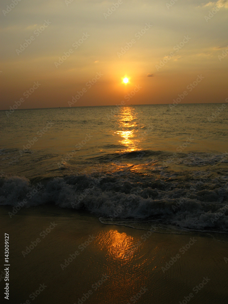 Beautiful sunset on the Indian ocean, on the beach, surf, foam, sand, Bentota, Ceylon, Sri Lanka