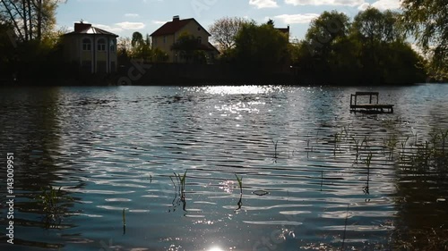 Small vaves on the river. Beautiful tranquil background with ripple. Countryside life far from big city. photo