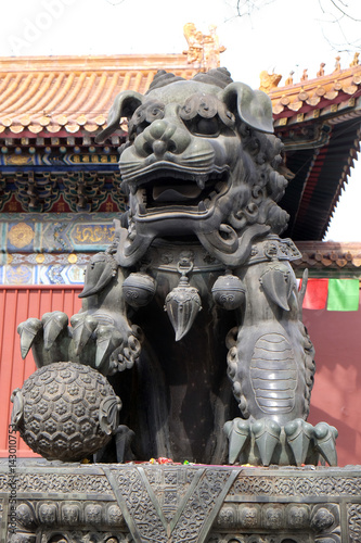 Bronze imperial lion at the gate of Lama Temple Yonghe Lamasery. It is one of the largest and most important Tibetan Buddhist monasteries in the world in Beijing, China