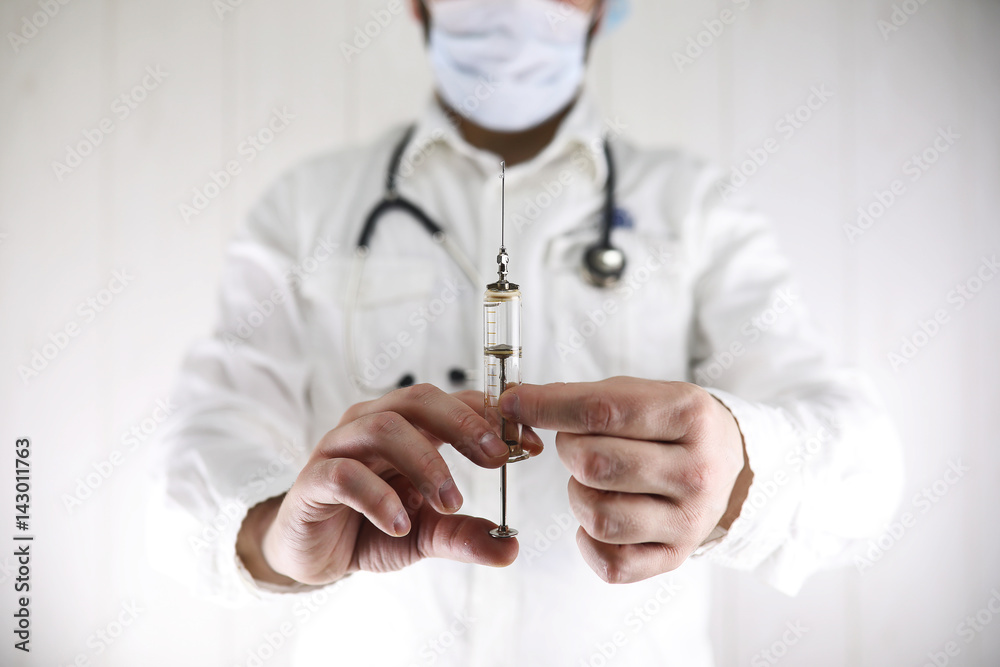 Crazy bearded doctor in a white coat and old syringe Crazy bearded doctor in a white coat and old syringe