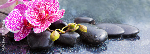 Spa concept with zen stones and orchid.