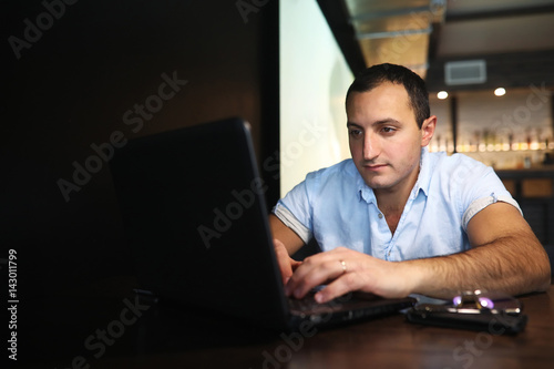 Armenian handsome man working behind laptop