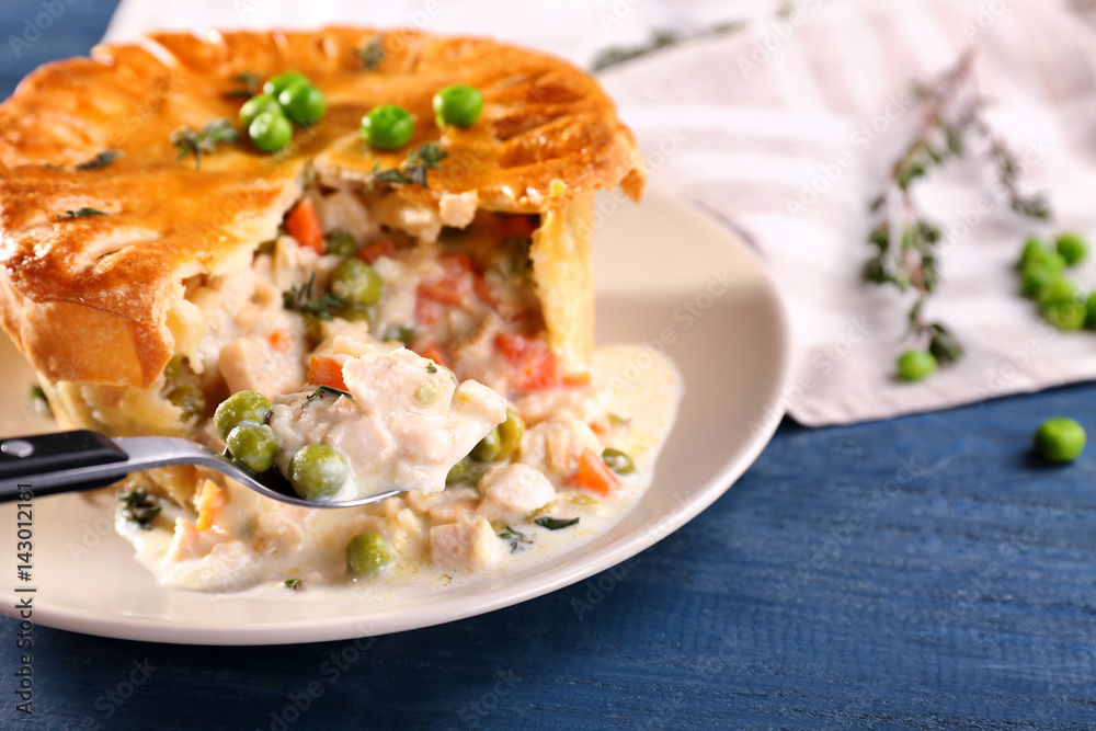 Tasty chicken pot pie with green peas on plate Tasty chicken pot pie with green peas on plate