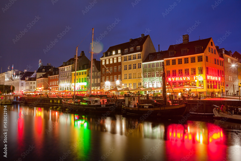 COPENHAGEN, DENMARK - 25 JUN 2016: Fairytale Nyhavn canal at blue hour, illuminated houses and street
