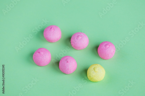 photo of tasty pink and yellow marshmallows on the wonderful green studio background