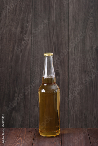 bottle of beer on a wooden background