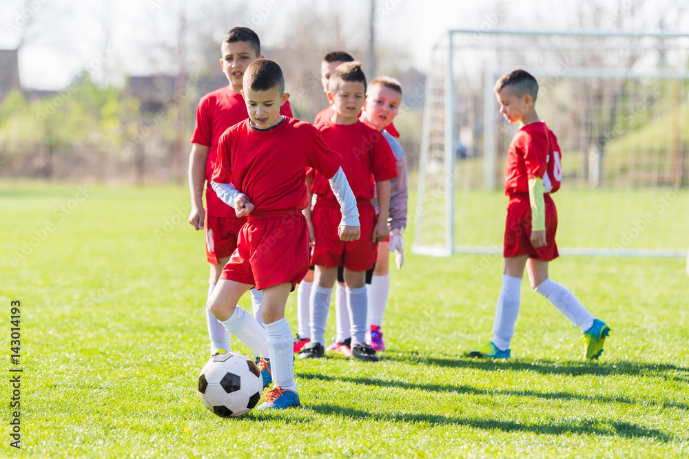 Obraz premium Kids soccer football - children players exercising before match on soccer field