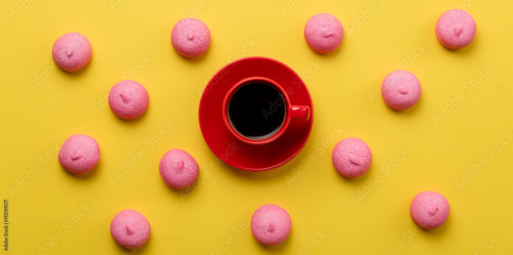 photo of tasty pink marshmallows and cup of coffee on the wonderful yellow background photo of tasty pink marshmallows and cup of coffee on the wonderful yellow background