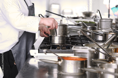 Chef in the kitchen in the restaurant 