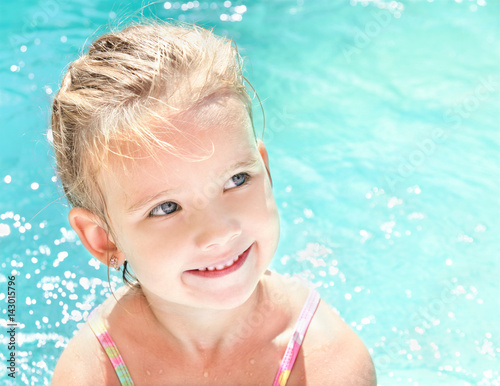 Pretty little girl in swimming pool