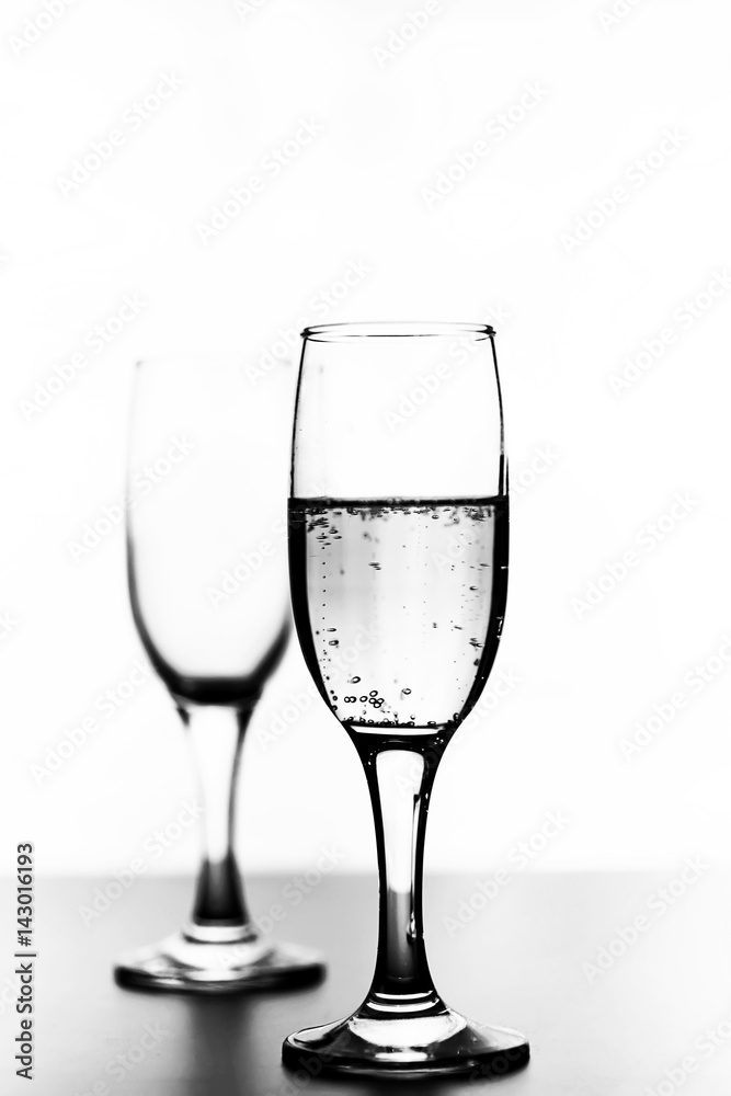 monochrome photo of champagne on white table on white background