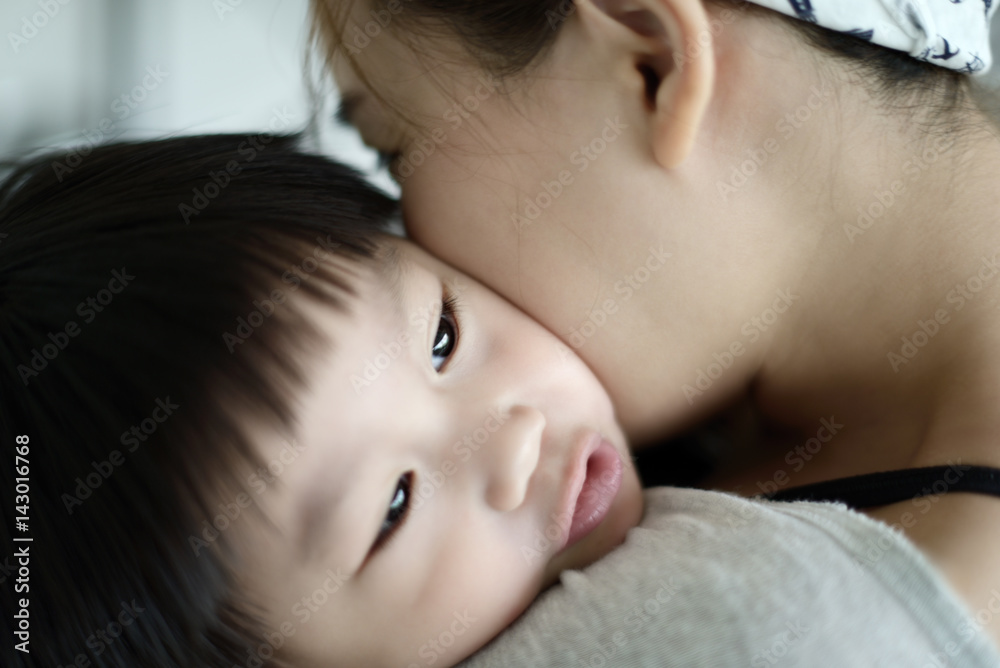 Happy mother embracing and kissing her son Happy mother embracing and kissing her son