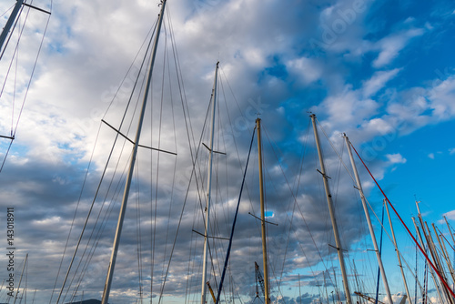 Boats masts under clouds