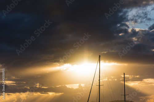 boat masts under a dark sky