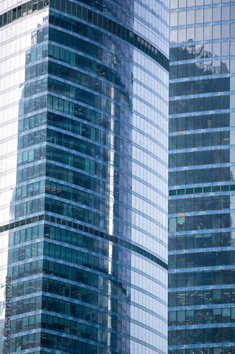 Modern office buildings, skyscrapers with reflection in windows.