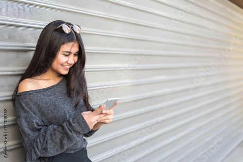 Free Download young happy Woman talikng and texting message with her mobile phone - GFXLoad