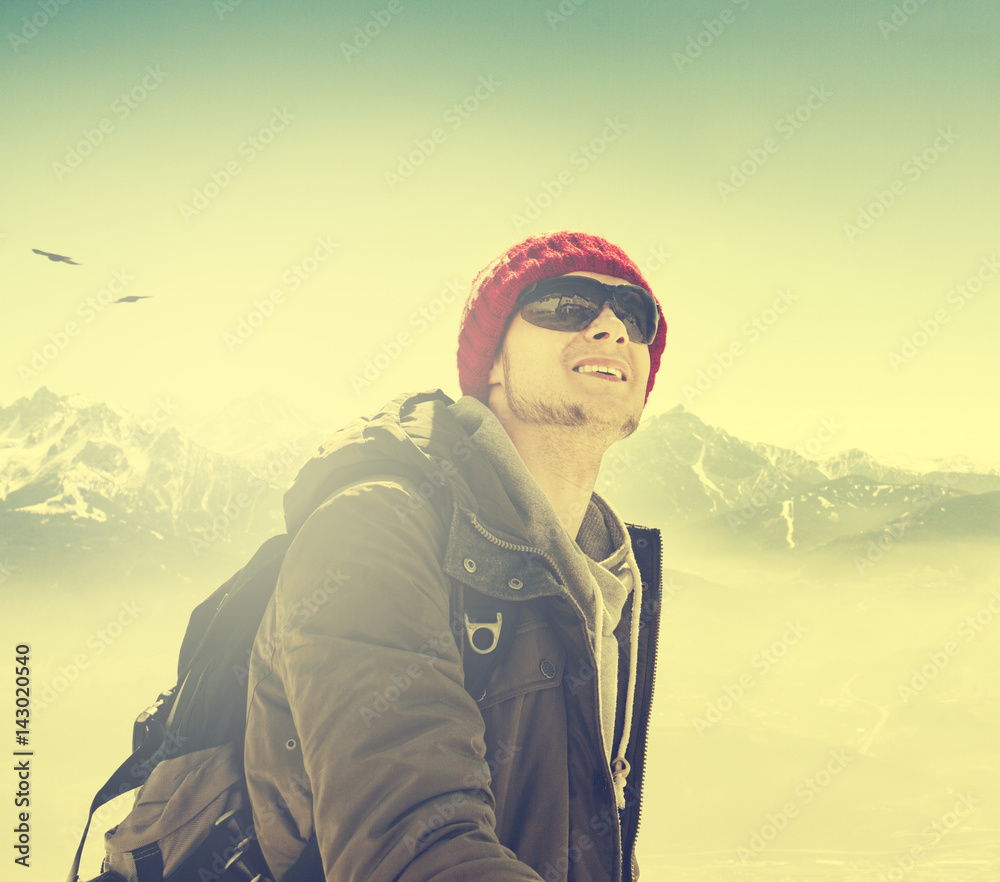 Young hiking man sportsman or traveler with backpack staying and looking on horizon. Toning. Young hiking man sportsman or traveler with backpack staying and looking on horizon. Toning.