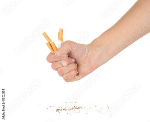 Human hand crushing cigarettes on white background