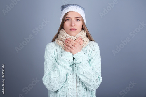 Sick young woman wearing wa...