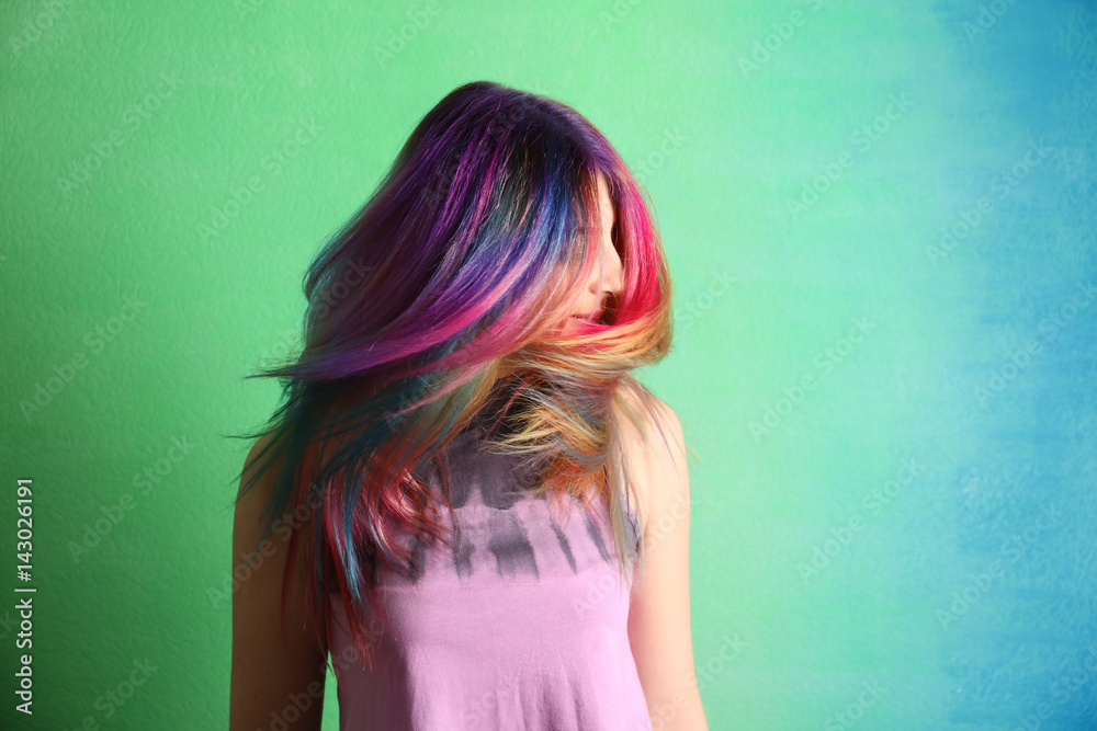 Trendy hairstyle concept. Young woman with colorful dyed hair on color background Trendy hairstyle concept. Young woman with colorful dyed hair on color background