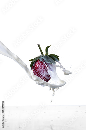Strawberry fruit with milk splash on white background