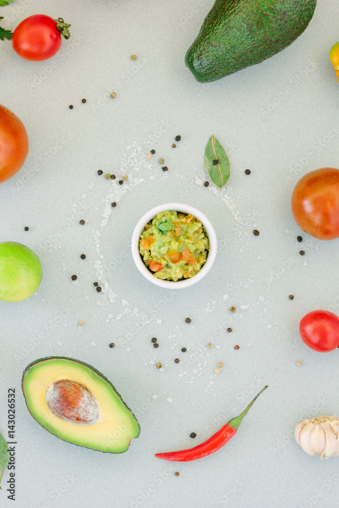 Traditional mexican avocado - vegetarian dip surrounded by its ingredients.