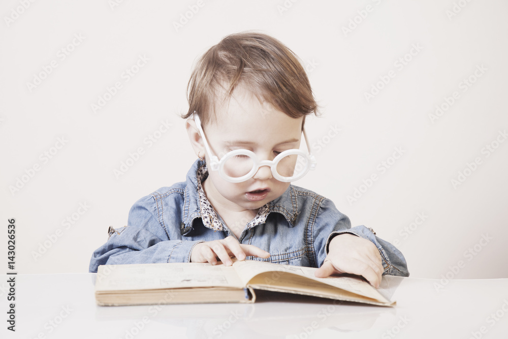 beautiful little child girl learns to read (success, education, development) beautiful little child girl learns to read (success, education, development)