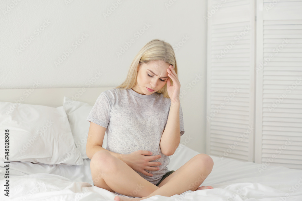 Young pregnant woman suffering from headache at home Young pregnant woman suffering from headache at home