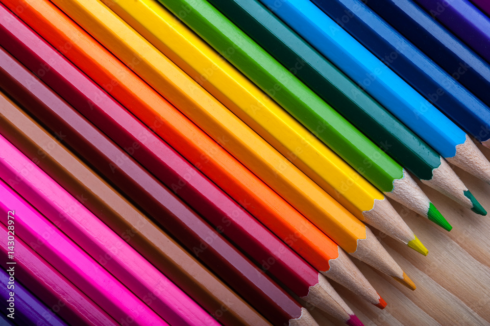Multicolored pencils on wooden table, top view. Multicolored pencils on wooden table, top view.
