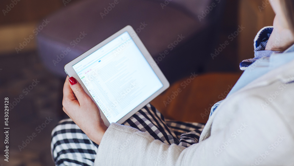 Naklejka premium Woman Talking on Phone and Looking at Tablet