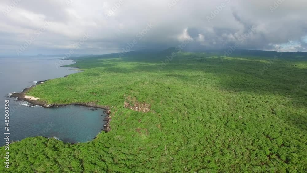Aerial view of lush jungle landscape of San Cristobal island coast, tropical paradise of Puerto Baquerizo Moreno, Galapagos capital, Ecuador