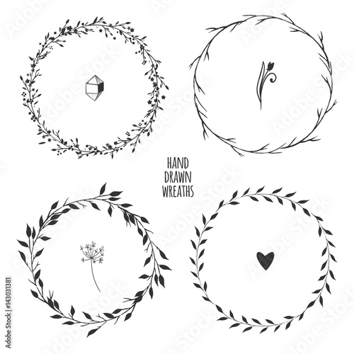 Set of four hand drawn floral wreaths for spring design isolated on white. Vector illustration.