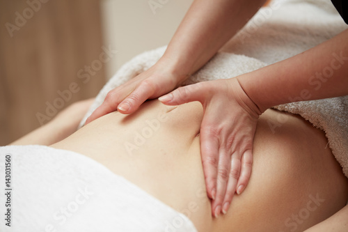 beauty  holidays and spa concept - woman in spa salon getting massage
