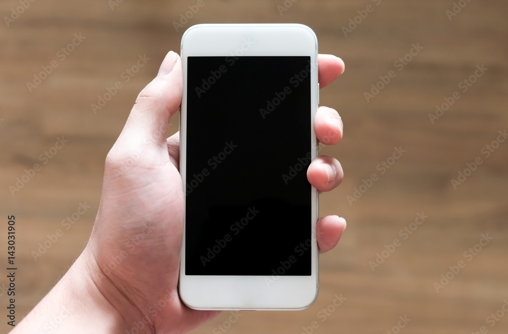 Man's hand holding white smart phone  in vertical direction