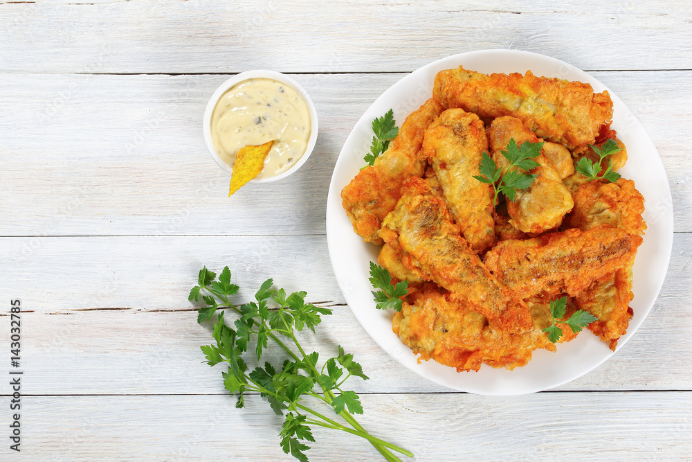 fried fish decorated with parsley, top view fried fish decorated with parsley, top view