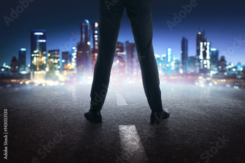 Businessman feet with black leather shoes standing on the street