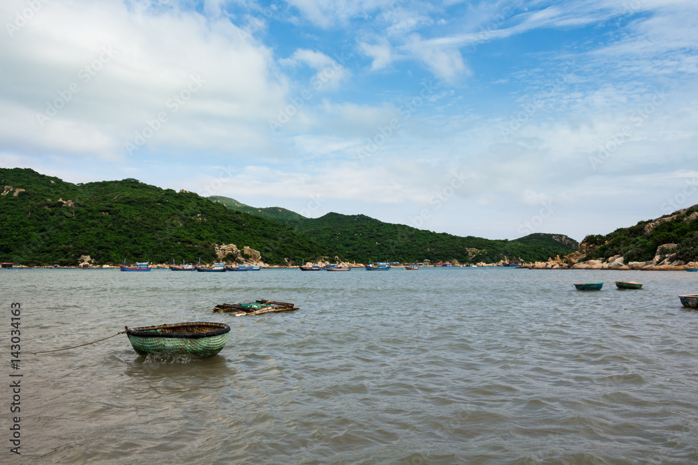 Fishing round boats in the sea with hills view in Vietnam