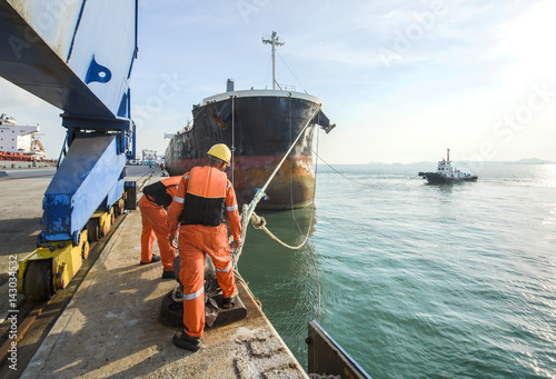 Photography mooring gangs attending to un-berth the ship on sailing departure from the termi