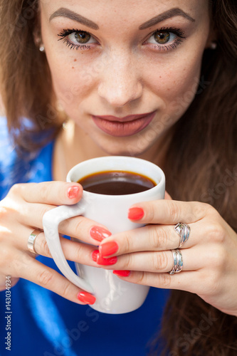 Gorgeous young woman drinking a cup of coffee. Coffee drinker.