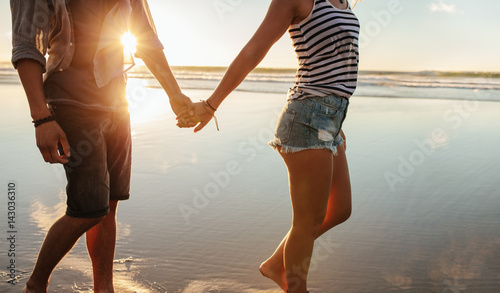 Loving couple strolling on the shore