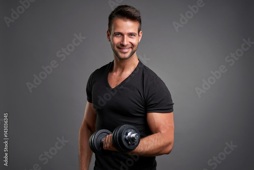 Young man lifting weight
