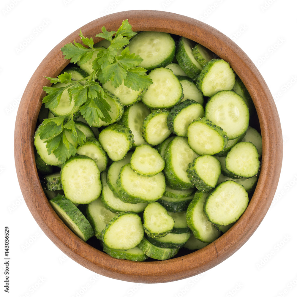 Fresh slice cucumber in wood bowl on white background. Fresh slice cucumber in wood bowl on white background.